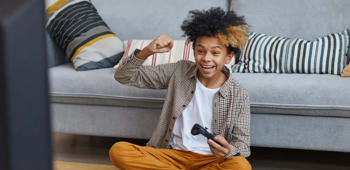 happy boy playing videogames