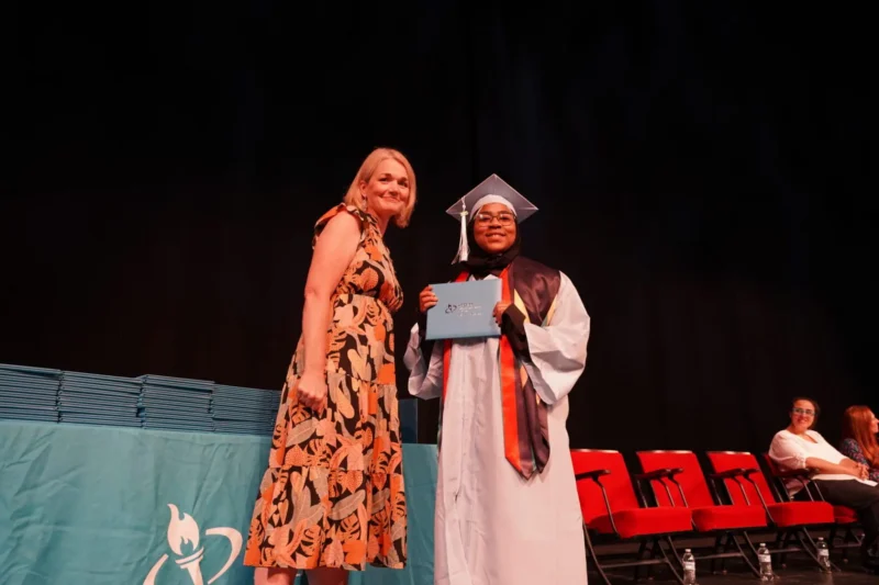 director and student with diploma
