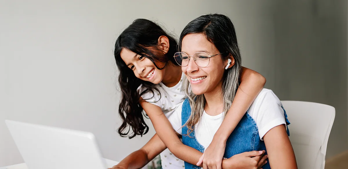 mom and girl looking the computer