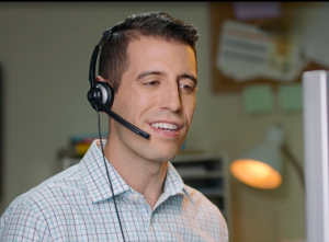 Teacher wearing a black pair of headphones with mic